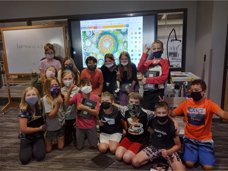 students in front of collaboratively created Dot Day sticker board